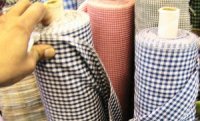 rolls of small black, green and blue checked fabirc