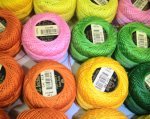 roles of bright orange, green yellow and pink cotton